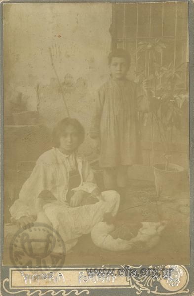 Portrait of two children with geese.