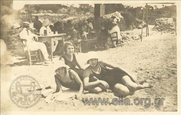 Three women on the beach .