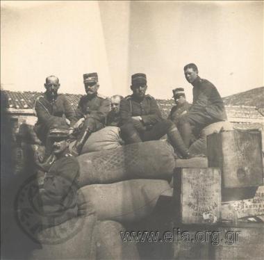 Crown Prince Konstantinos, Princes Georgios and Paul, General Panagiotis Dagklis and staff officer Victor Dousmanis sitting on bags at the site of Emin-Aya Inn. The Balkan Wars