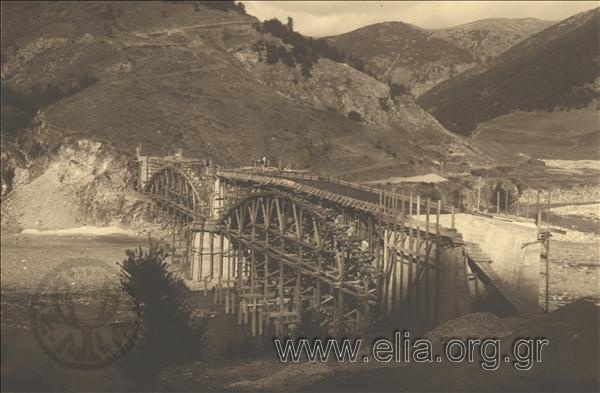 The construction of the bridge at Nestos river. The crew of labourers installs the iron grid of the deck.