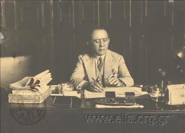 Minister for Social Relief in his office