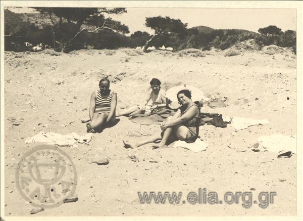 Iris with her company in a sandy beach