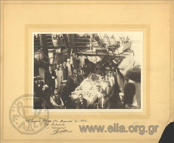 Eastern dinner on the steamboat Andros. The crew and the passengers in a commemorative photo