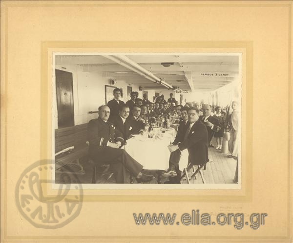Eastern dinner on the steamboat Andros. The captain and passengers in a commemorative photo