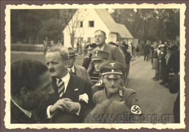 Mayor of Athens Kostas Kotzias on a wagon with Third Reich militraries on a visit to a hospital
