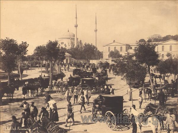Main road with buggies. In the background the mosque Dolma Bahce stands out.