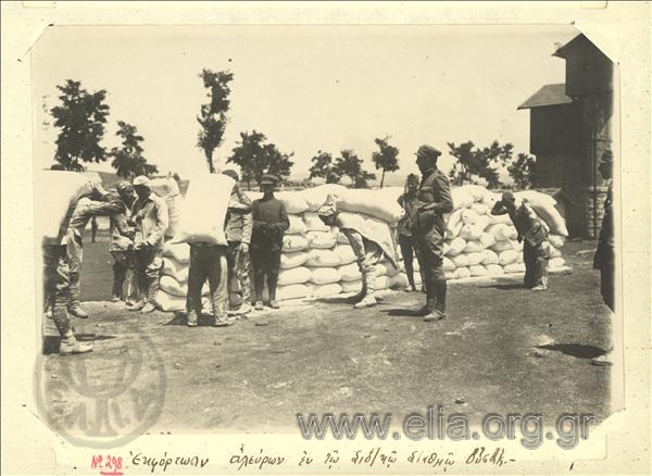 Asia Minor campaign, unloading flour under the supervision of a Greek  officer at the Usak railroad station.