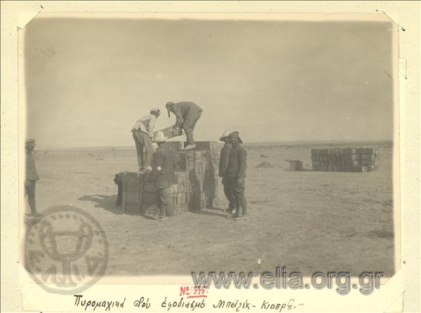 Asia Minor campaign, soldiers stack boxes with ammunition at the refitting area of Beylik Kopru.