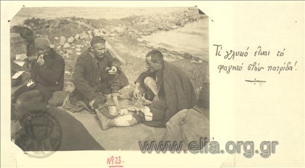 Asia Minor campaign, return of hostages:incoming soldiers eat on a beach, probably on the islet of Agios Georgios.