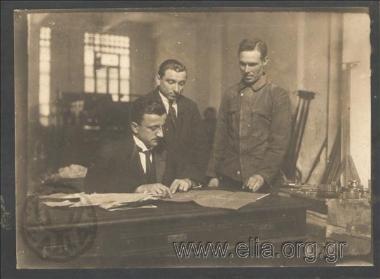 Men studying printed matter at a printer's