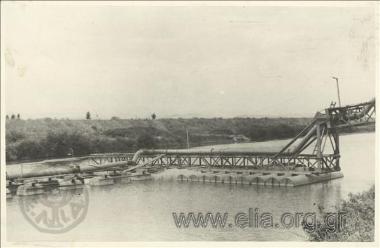 Drainage work at Lake Ioannina, reshaping of the peripheral canal around the lake: the far end support of the piping for sending out muck scrapings from the lake sucked up by dredger 