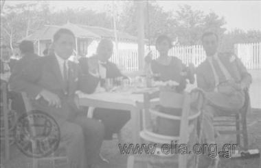 The company in a taverna. Georgios Vafiadakis first from the left .