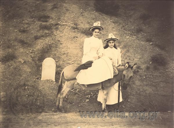 Aikaterini K. Vourou on a donkey, her sister Maria next to her.