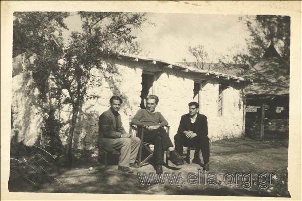 Co-exiles. From left, former officer Theodoros Karolos, Dimitris Fotiadis and  former officer Makis Troϊanos in front of the house where they stayed while in exile.