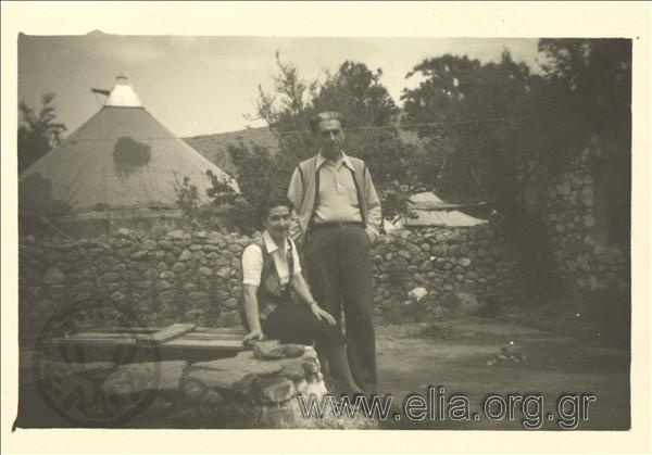 Exiled Dimitris Fotiadis and his wife Katina Fotiadis (visitor) at a well at Agios Stratis