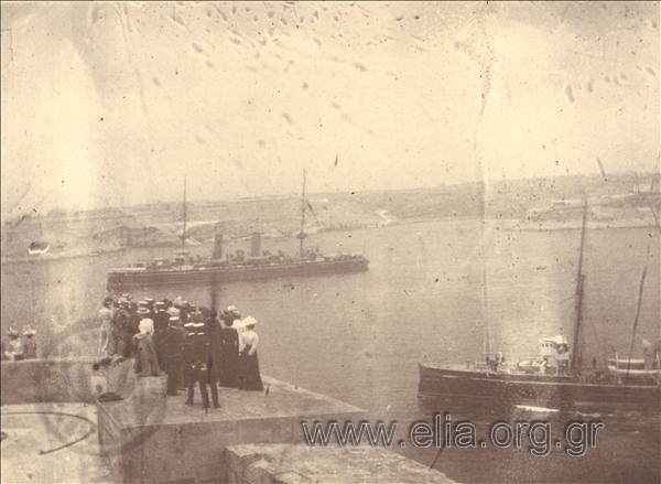 Port of Valetta. Navy officers and civilians gazing out at sea (left)