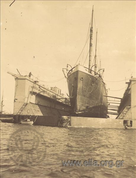 Ship at the dock of the Royal Navy naval station for repair.