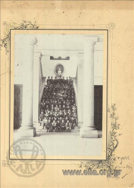 Students posing in a commemorative photograph, seated on the main staircase of the Zervoudakis mansion.