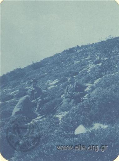 Company of men resting on a slope