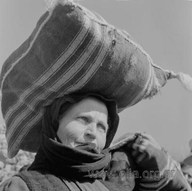 Η μεταφορά των σακιών - χωρική κουβαλά σακί στο κεφάλι της.