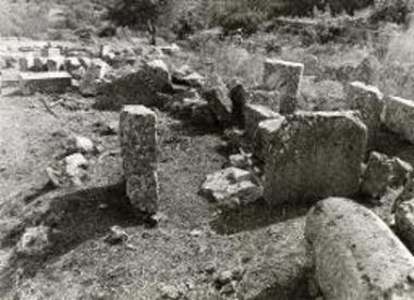 Ο βωμός των Μουσών πρίν από την αποκατάσταση. Η όρθια πλάκα αριστερά είναι ο ορθοστάτης που αποκαταστάθηκε.