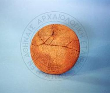 Broken lid with incised decoration.