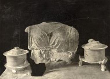 Pyxis and torso of a clay statuette.