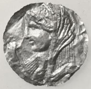 Round gold foil with an impression of a female head