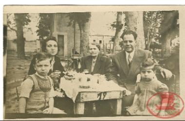Maria Triantafyllidou in infancy, with her family at an outdoor meal in Constantinople