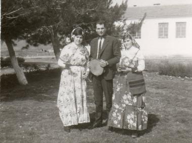 Nikitas Karavasileiadis with two girls wearing local costumes in 1960