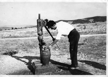 Nikitas Karavasileiadis fills a jug from a well in the Volvi region