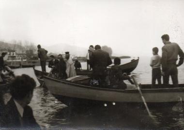 Religious ceremony with a priest in the waters of Megali Volvi