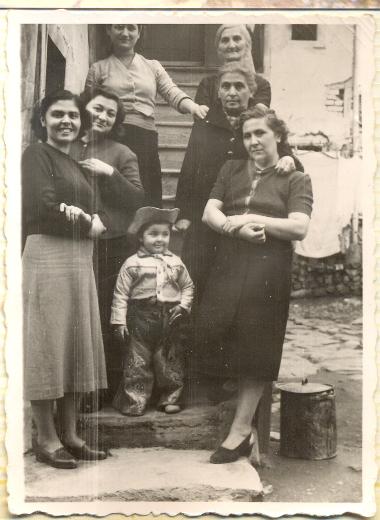 Sophia Kotsogiannidou (right) with her young son Lazaros and visiting relatives who had come from Russia in 1927, at the entrance of their house in Lasani