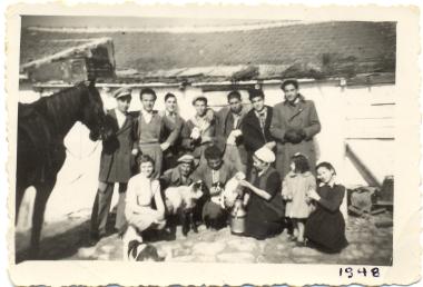 Workers at the Kourbetis stable in Votsi with small animals and children