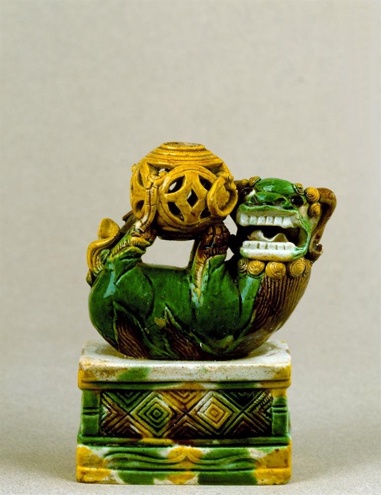 Buddhist lion figure, porcelain with moulded decoration and enamels