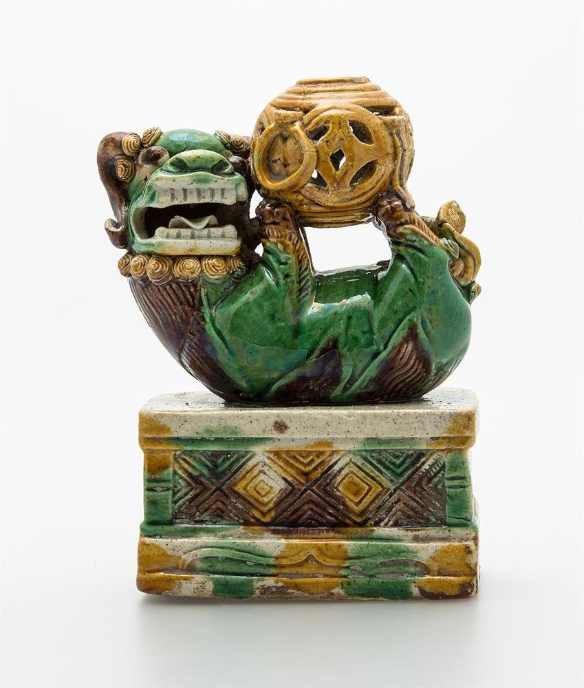 Buddhist lion figure, porcelain with moulded decoration and enamels