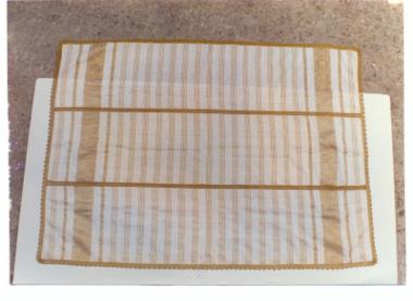 Παραλληλόγραμμο ύφασμα από τρία φύλλα με ριγωτή διακόσμηση.