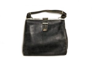 Handbag, black leather and lining, inserted purse, metal clasp, leather string and handle
