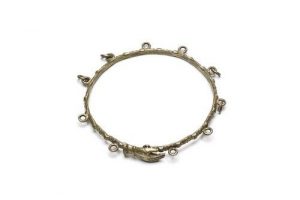 Silver bangle with hand-shaped link and eyelets for pendants.