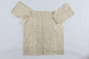Woman's chemise, cream silk with woven vertical stripes, cuffs edged with crochet trims, without neckline, unused, probably belonged to a member of the the local Jewish community.