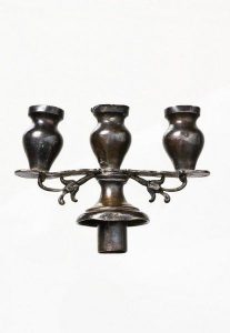 Silver component with three candleholders.