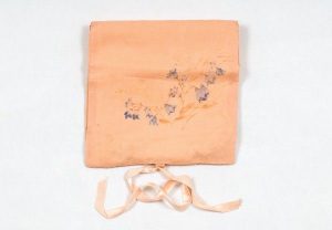 Salmon silk case for handkerchief with blue flowers.