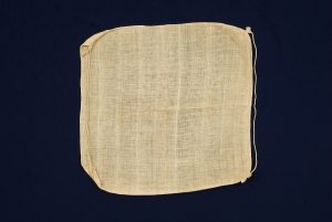 Crude cotton with strings, for unknown use.
