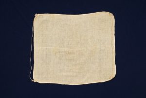 Crude cotton with strings, for unknown use.