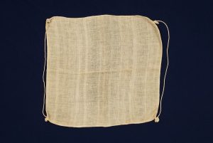 Crude cotton with strings, for unknown use.
