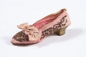 Single low-heel court shoe, pink silk with spiraled gold thread embroidery, decorated with pink silk bowknot, probably belonged to a member of the the local Jewish community.