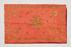 Coral silk with gold embroidery in couching technique, spiraled threads and sequins, central floral ornament, corner motifs and foliate border, Ioannina (?).