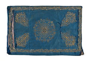 Cerulean blue silk with gold embroidery, central floral ornament, corner motifs and foliate border.
