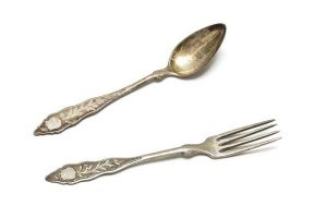 Silver cake fork and spoon with floral engraving.