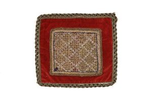Wine red velve square piece with hand made gold and silk thread lace, belonged to Rachel Covomid.